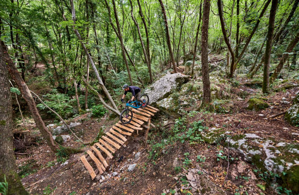 istock Enduro biker descending over challenging drop on a self-constructed trail in the woods 1349010224