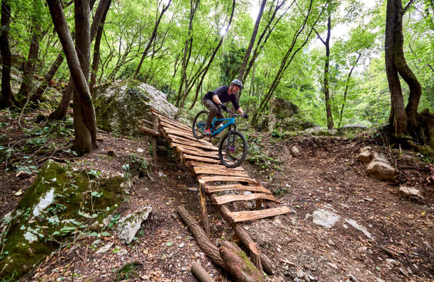 istock Enduro biker descending over challenging drop on a self-constructed trail in the woods 1349010244