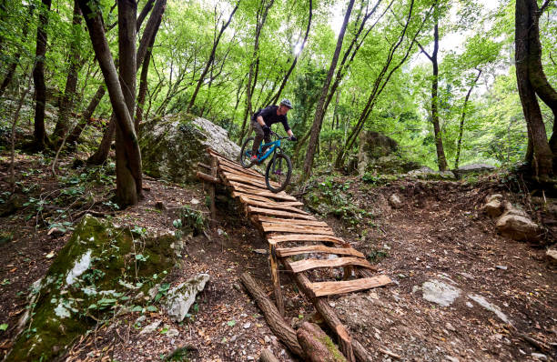 istock Enduro biker descending over challenging drop on a self-constructed trail in the woods 1349010289
