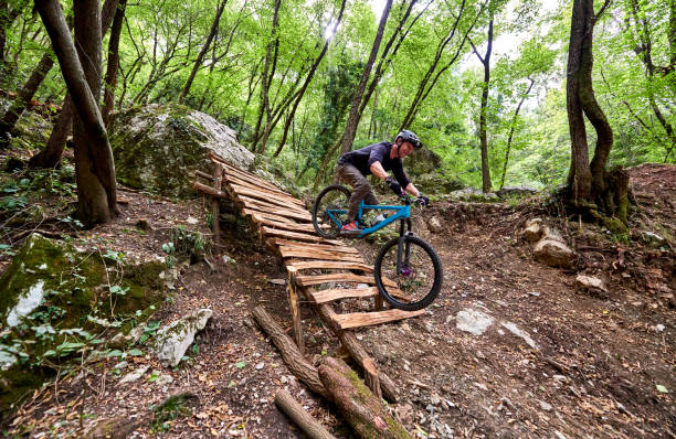 istock Enduro biker descending over challenging drop on a self-constructed trail in the woods 1349010319