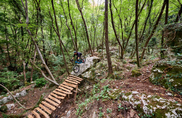 istock Enduro biker descending over challenging drop on a self-constructed trail in the woods 1349010386