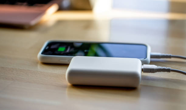 istock A smartphone is charged from a small white power bank. 1349010486
