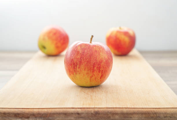 istock red juicy apples on a wooden table, on grey background. 1349010601