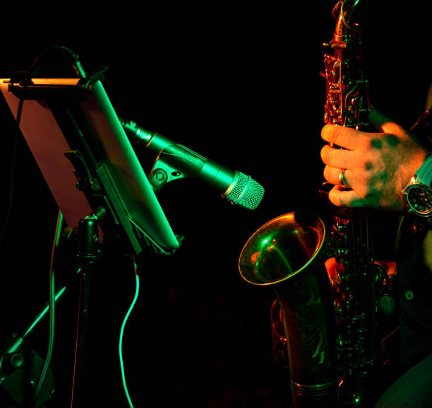 istock artist musician plays the saxophone illuminated by orange light 1349010731
