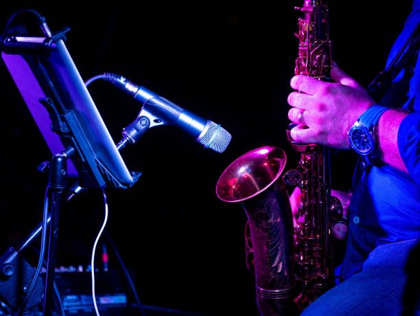 istock artist musician plays the saxophone illuminated by blue light 1349010938