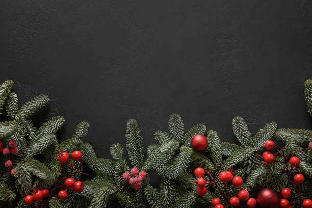 istock Christmas festive frame with red baubles on black. Xmas greeting card. 1349012226