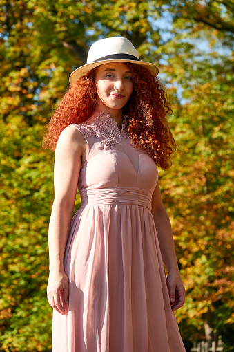 Red haired young beautiful woman enjoying summer sun