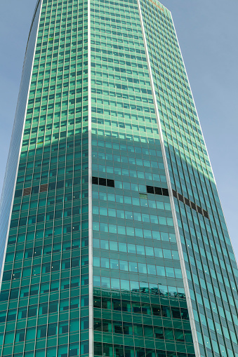 Modern office buildings in a business district. Bottom view of a glass and concrete skyscraper