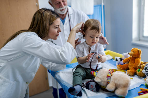 istock Doctor examining baby boy with stethoscope 1349014054