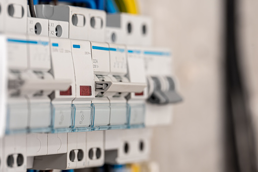 Voltage switchboard with circuit breakers are in the ON and OF positions in the big electric box for electrical distribution panel, and temporary electric cables are switched.