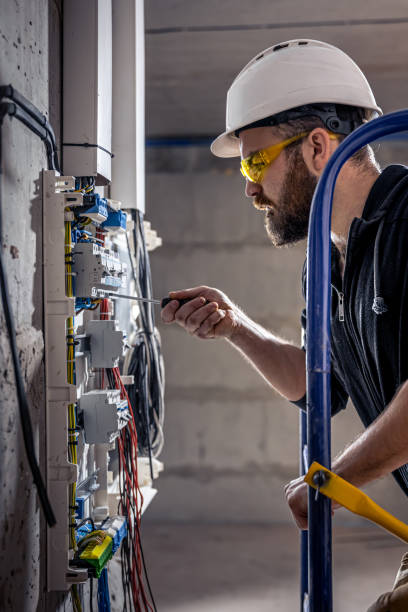 istock A male electrician works in a switchboard with an electrical connecting cable. 1349015001
