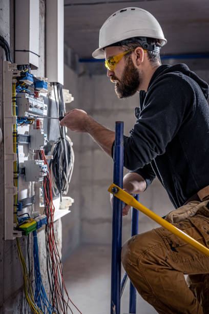 istock A male electrician works in a switchboard with an electrical connecting cable. 1349015005
