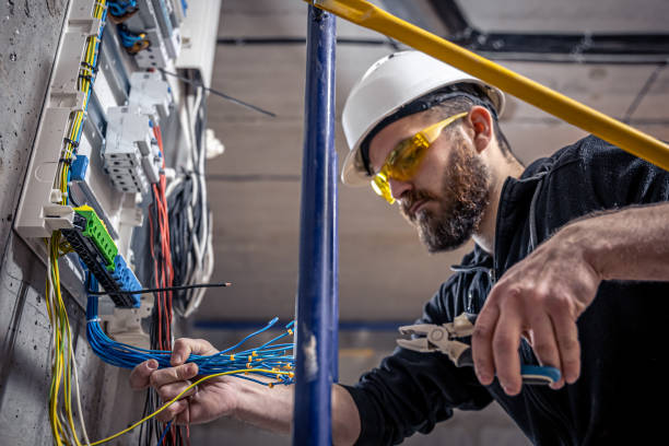 istock A male electrician works in a switchboard with an electrical connecting cable. 1349015011
