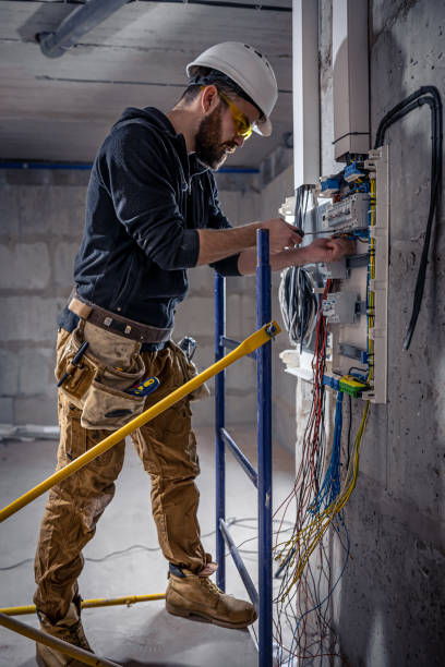 istock A male electrician works in a switchboard with an electrical connecting cable. 1349015018