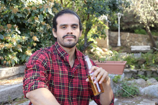 istock Bearded man sitting on staircase enjoying a beer 1349015181