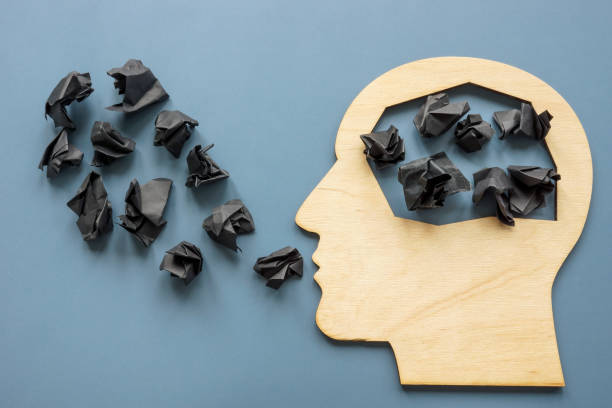 istock Head shape and black paper balls as negative thoughts. 1349017062