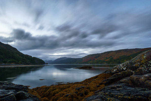 view from loch duich at loch alsh with moving clouds on morning before sunrise, dornie, scotland - long exposure imagens e fotografias de stock