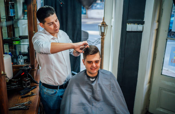 istock Professional barber cutting man's hair in salon 1349018214