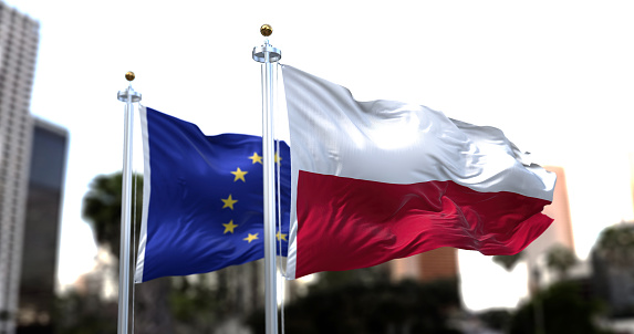 Las banderas de Polonia y la Unión Europea ondeando al viento photo