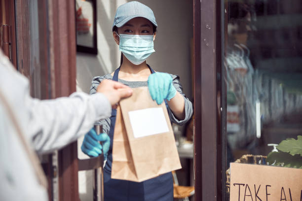 istock Customer taking package with food from cashier at cafe 1349018412