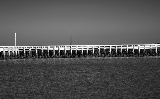 White pier crosses the sea