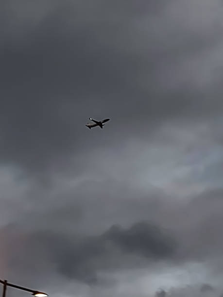 istock An airplane in the night sky 1349020048