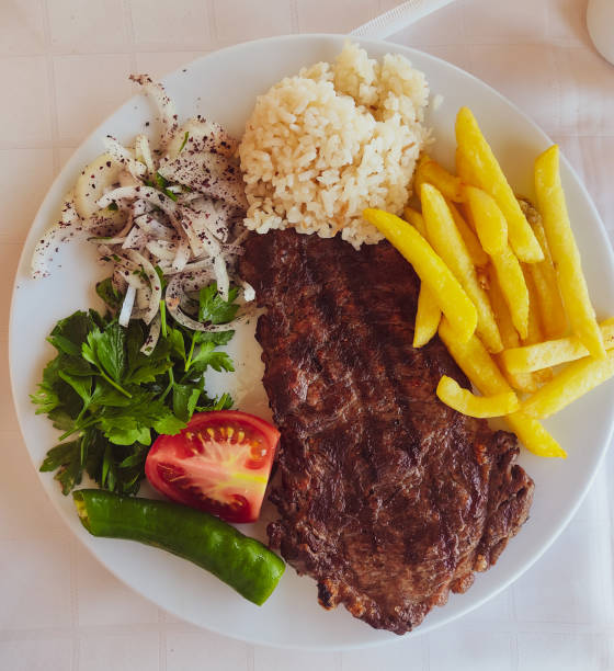 Steak with French fries, rice and vegetables at a diner in Princes island turkey