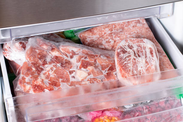 istock Frozen meat in plastic package in the freezer. 1349021214