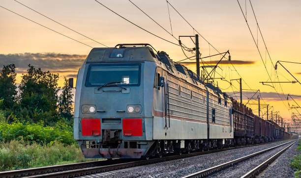 istock Electric locomotive hauling a cargo train at sunset 1349021652