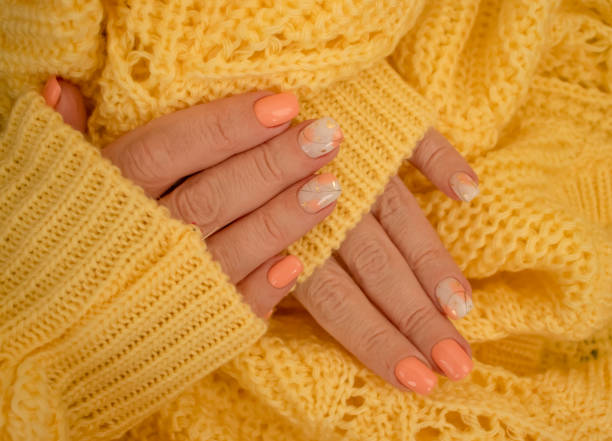 istock female hands beautiful manicure warm fabric sweater yellow 1349023019