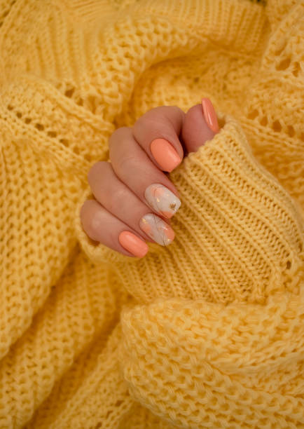 istock female hands beautiful manicure warm fabric sweater yellow 1349023202