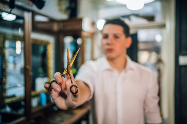 istock Barber in his vintage barber shop 1349023285