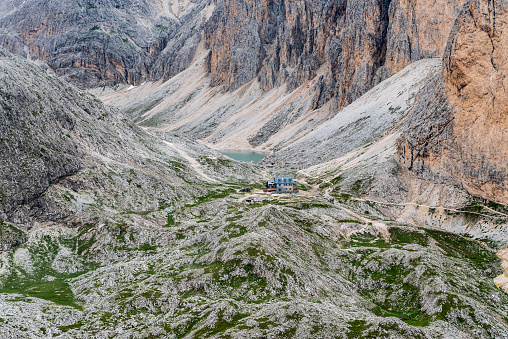 Rifugio Antermoia hut and Lago di Antermoia lake from Mantel mountain peak in Dolomites mountains in Italy