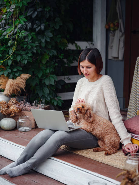 istock woman with laptop working outdoors in garden 1349024267