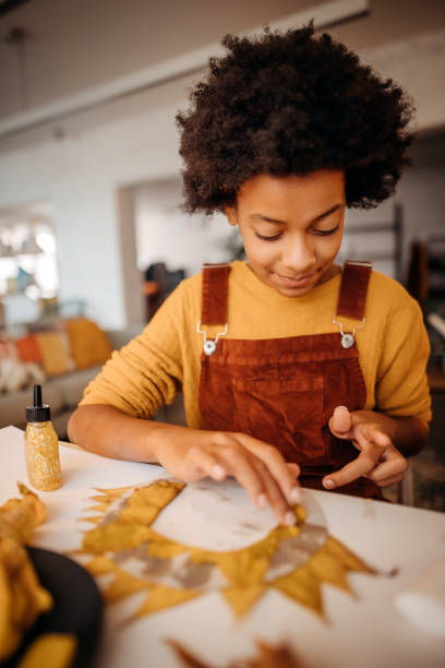 Girl makes something out of leaves