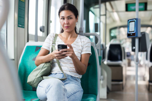 istock Woman with smartphone sitting in tram 1349028505