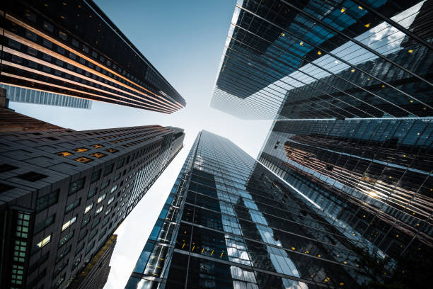 business and finance, looking up at high rise office buildings in the financial district of a modern metropolis - storstadsbild bildbanksfoton och bilder
