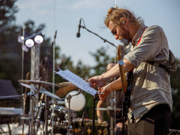 istock Handsome man guitarist studying musical notes outdoors 1349032006