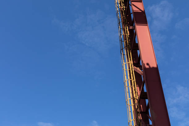 istock Upright metal girders with attached caged ladder against a blue sky, creative copy space 1349032150