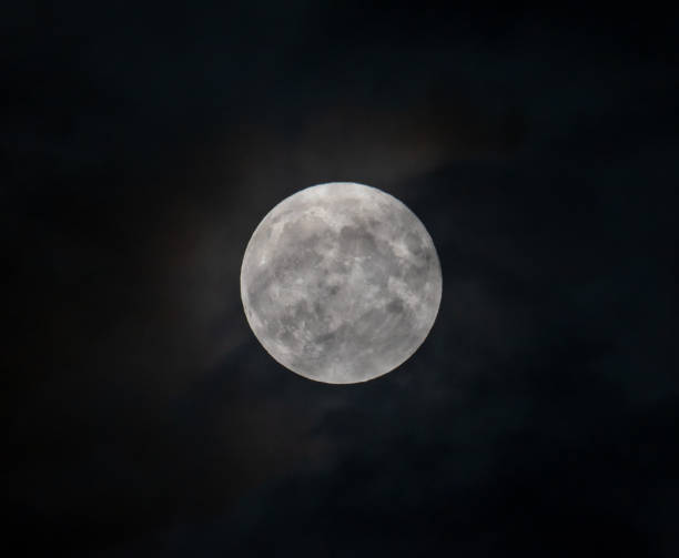 istock Full moon on the background of clouds in the night scenery 1349034191