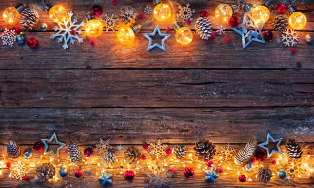 istock Christmas Lights - Decorations Illuminated With String Lights On Dark Wooden Table 1349038800