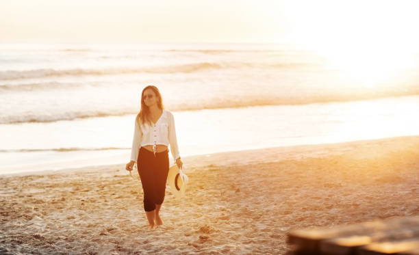 istock Woman leisurely strolling on the seaside 1349040706