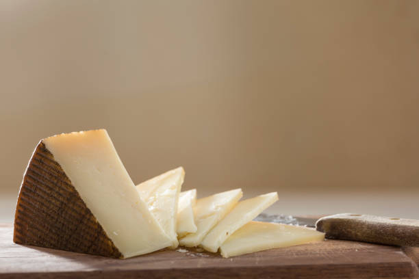 istock knife splitting cheese on wooden board 1349040848