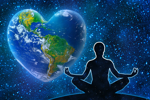 Yoga figure against universe background. Earth in the shape of a heart, ecology and environment concept  - Elements of this image furnished by NASA  (source https://www.nasa.gov/content/kepler-78b-first-earth-sized-rocky-planet, program PSCS6).