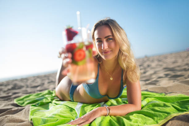 istock Blonde young woman drinking cocktail 1349041738