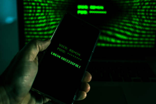 istock Hand with smartphone doing successful login in a digital network. Display with green numbers in background. Hacker forced the system. Technology, communication, security, protection, intrusion concept 1349043128