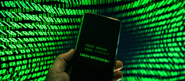istock Hand with smartphone doing successful login in a digital network. Display with green numbers in background. Hacker forced the system. Technology, communication, security, protection, intrusion concept 1349043158