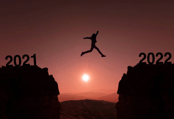 istock New Year Concept From 2021 to 2022, Silhouette Man jumping 1349043225