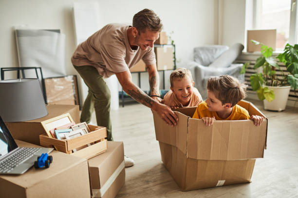 istock Two Boys Playing with Dad in New House 1349049449