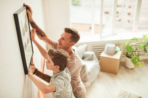 Father and Son Hanging Picture Together
